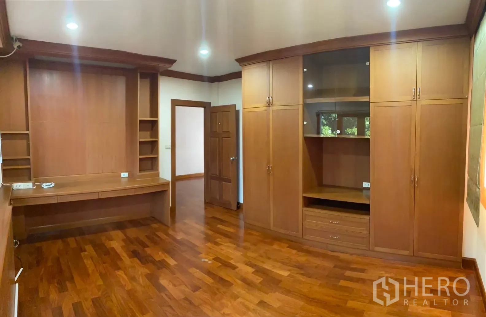 Detached House for rent in Watthana, Bangkok - Master bedroom with curved built-ins and doors to balcony.
