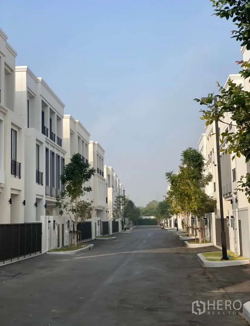 Detached House for rent or sale in Lat Krabang, Bangkok - Tree‑lined private street inside a gated modern housing community