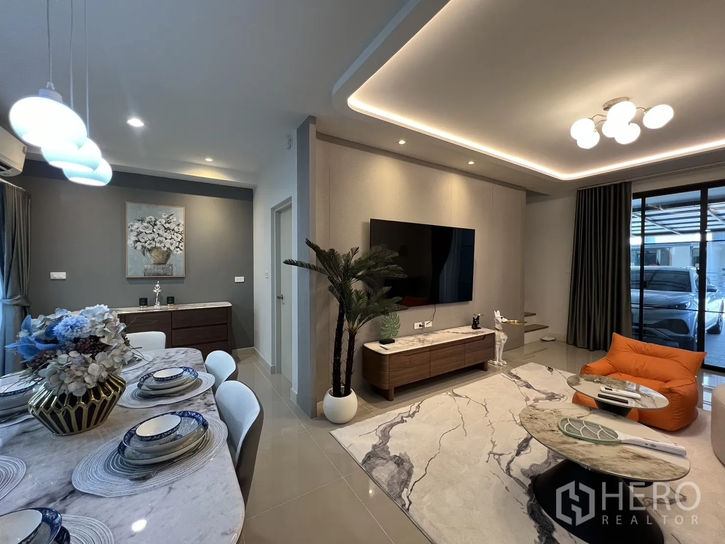 联排别墅 for rent in Bang Phli, Samut Prakan - 餐区通向客厅，配壁挂电视与氛围照明。
