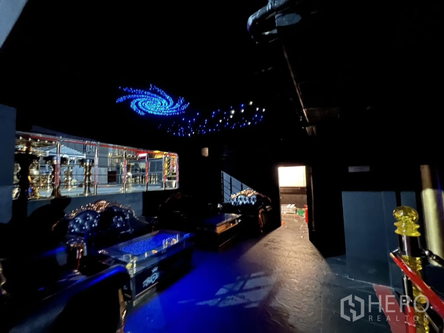 Retail Space for rent - Lounge zone with blue LED galaxy ceiling lights and leather sofas.