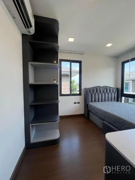 Detached House for rent or sale - Corner bedroom with custom shelving and upholstered bed.