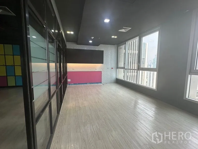 Office Space for rent in Bang Rak, Bangkok - Pantry nook with cabinets and corner windows offering city views.