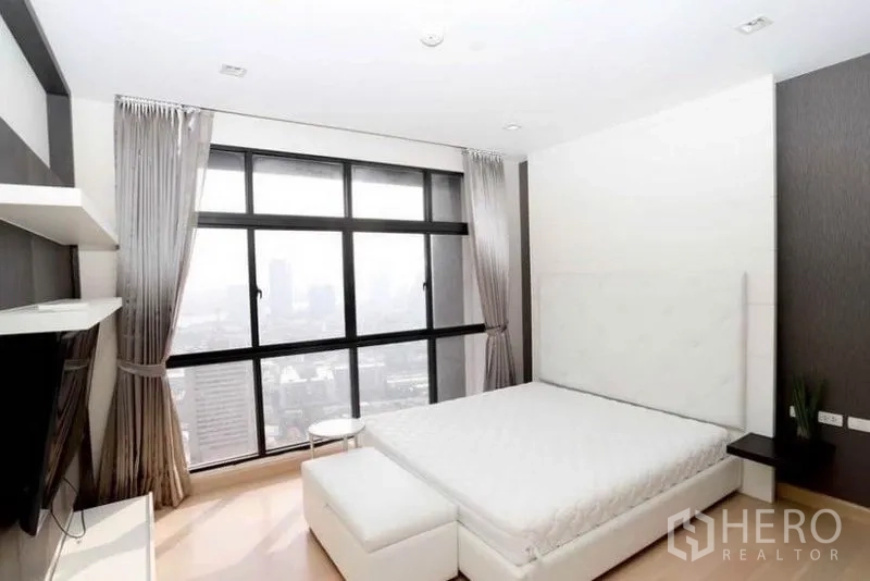 公寓 出租在Khlong San, Bangkok - 主卧配大床与通高落地窗，简约配色