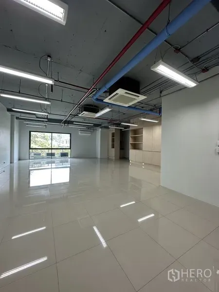 Office Space for rent in Khlong Toei, Bangkok - Spacious open office floor with LED strip lighting, cassette air-conditioning and polished tiles.