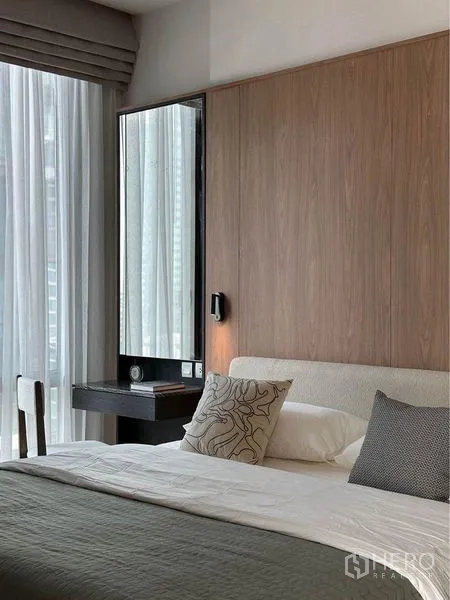 Condominium for rent in Pathum Wan, Bangkok - Cozy bedroom corner with dressing table, tall mirror and layered drapes.