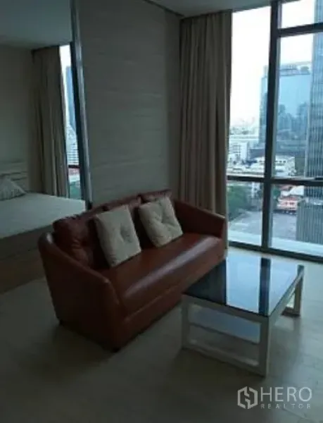 คอนโด ให้เช่าในWatthana, Bangkok - มุมนั่งเล่นโซฟาหนัง โต๊ะกลางกระจก หน้าต่างเต็มผนังวิวสกายไลน์เมือง