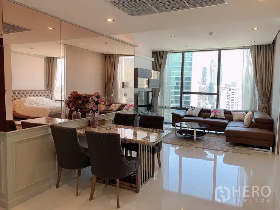 Condominium for sale - Wide view of open-plan condo with dining, lounge, and city panorama.