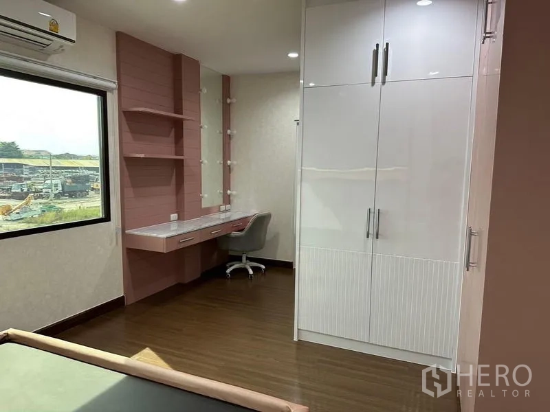 Detached House for sale in Saphan Sung, Bangkok - Bedroom corner showing vanity desk, shelves and tall closet.