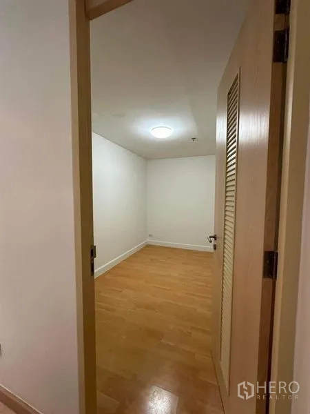 Condominium for rent or sale - Compact empty room with wood flooring and ceiling light, ideal as storage or maid’s room.