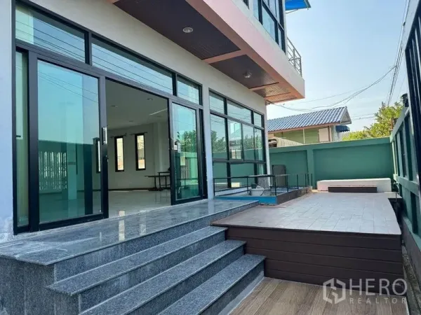 Warehouse for rent or sale in Mueang Samut Sakhon, Samut Sakhon - Two-storey office beside the warehouse featuring large sliding glass doors, stone steps, and a small deck.