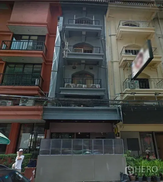 店屋 出租在Khlong Toei, Bangkok - 灰色四层店屋外立面，带小阳台与街边雨棚，位于曼谷瓦他那。