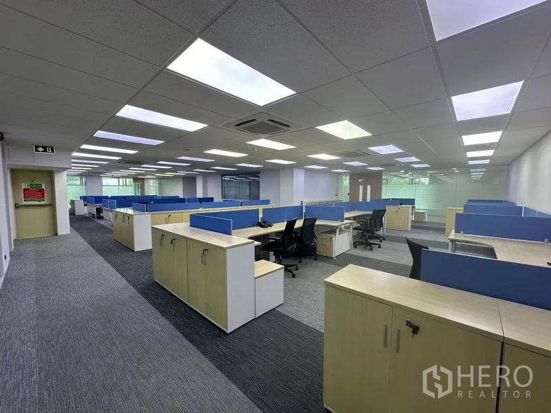 Office Space for rent - Spacious workspace featuring multiple cubicles, storage cabinets and large windows bringing natural light.