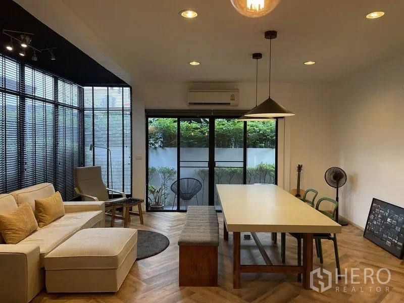 Detached House for sale in Sai Mai, Bangkok - Spacious living–dining room with sliding glass doors opening to a small garden patio.