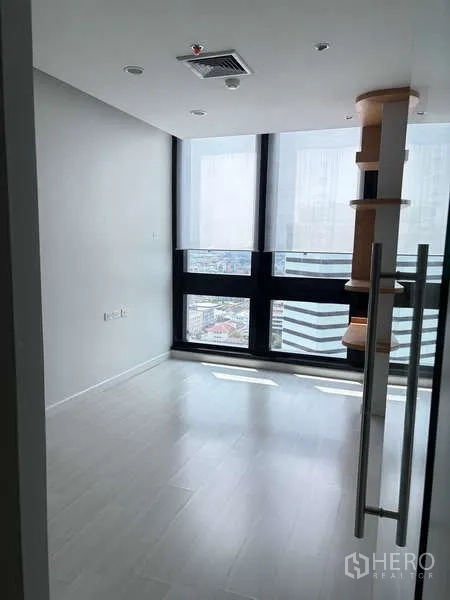 Office Space for rent in Bang Na, Bangkok - Private office with floor-to-ceiling windows, city view and built-in shelving.