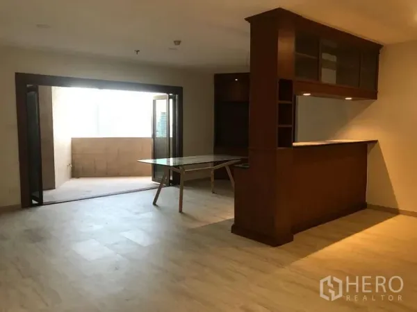 公寓 出售在Watthana, Bangkok - 餐区连接封闭式阳台，旁有内置木质吧台。
