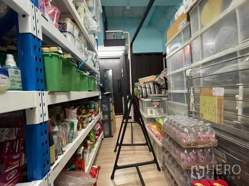 Townhouse for sale - Utility storage room with metal shelving and organized household supplies.