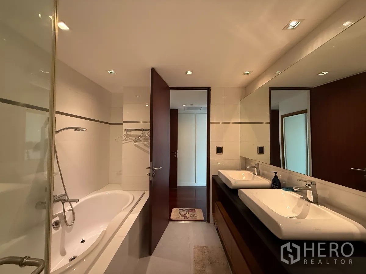 公寓 出租在Phaya Thai, Bangkok - 浴室配双台盆、长镜、浴缸与玻璃淋浴区。