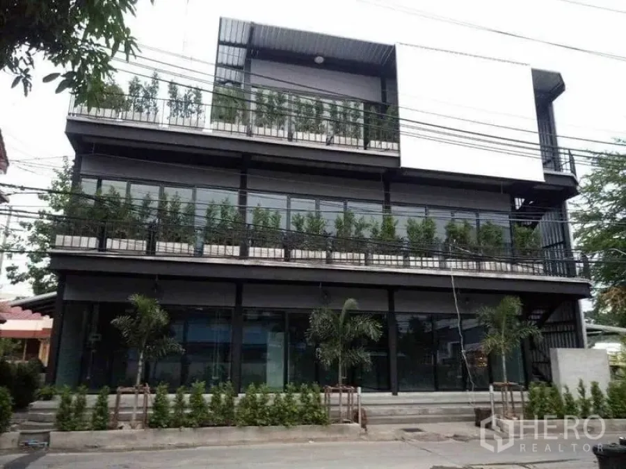 Home Office for rent in Din Daeng, Bangkok - Modern three-storey home office building with full-height glass and balcony planters.