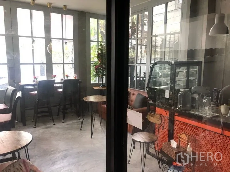 Retail Space for rent in Khlong Toei, Bangkok - Ground-floor cafe-style retail space with bar seating, glass display and large windows.