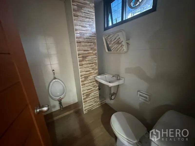 Office Space for rent in Bang Rak, Bangkok - Restroom with toilet, urinal, sink and tiled finishes.