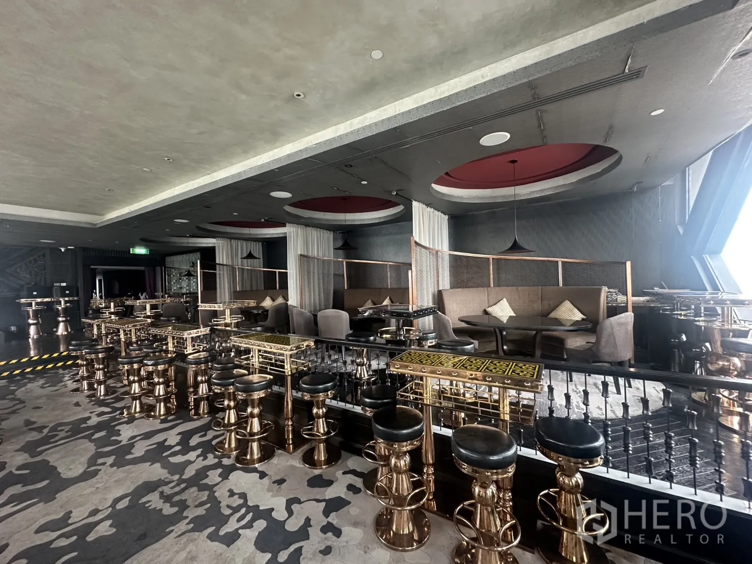 Retail Space for rent in Khlong Toei, Bangkok - Elevated seating area with bronze bar stools and semi-private booths.