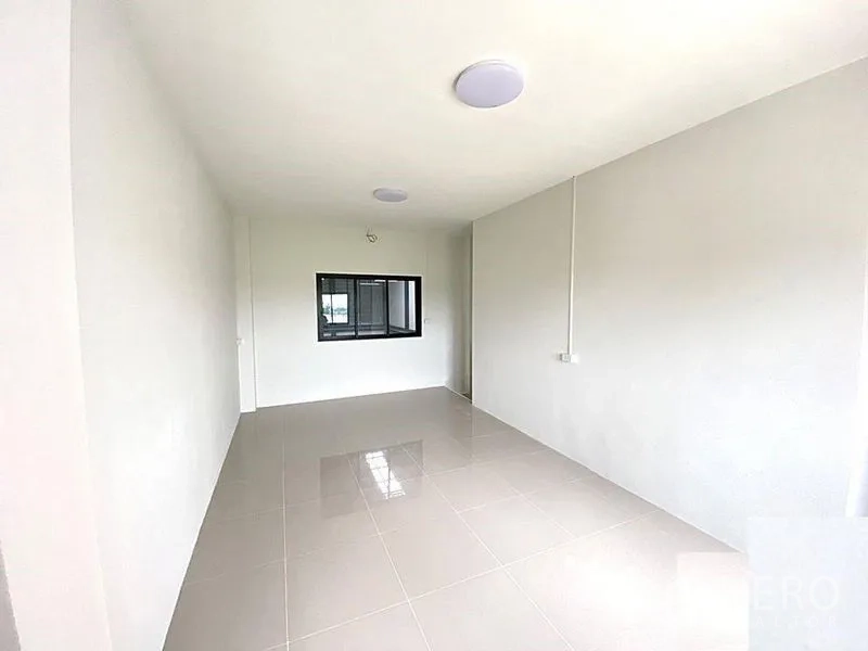 Factory for rent in Bang Bua Thong, Nonthaburi - Bright office or living room with tiled floor and internal window.