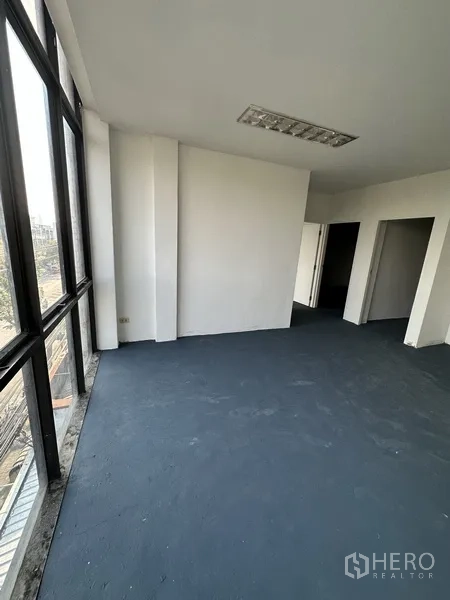 Shophouse for rent in Bang Na, Bangkok - Corner office area with panoramic windows and urban views.
