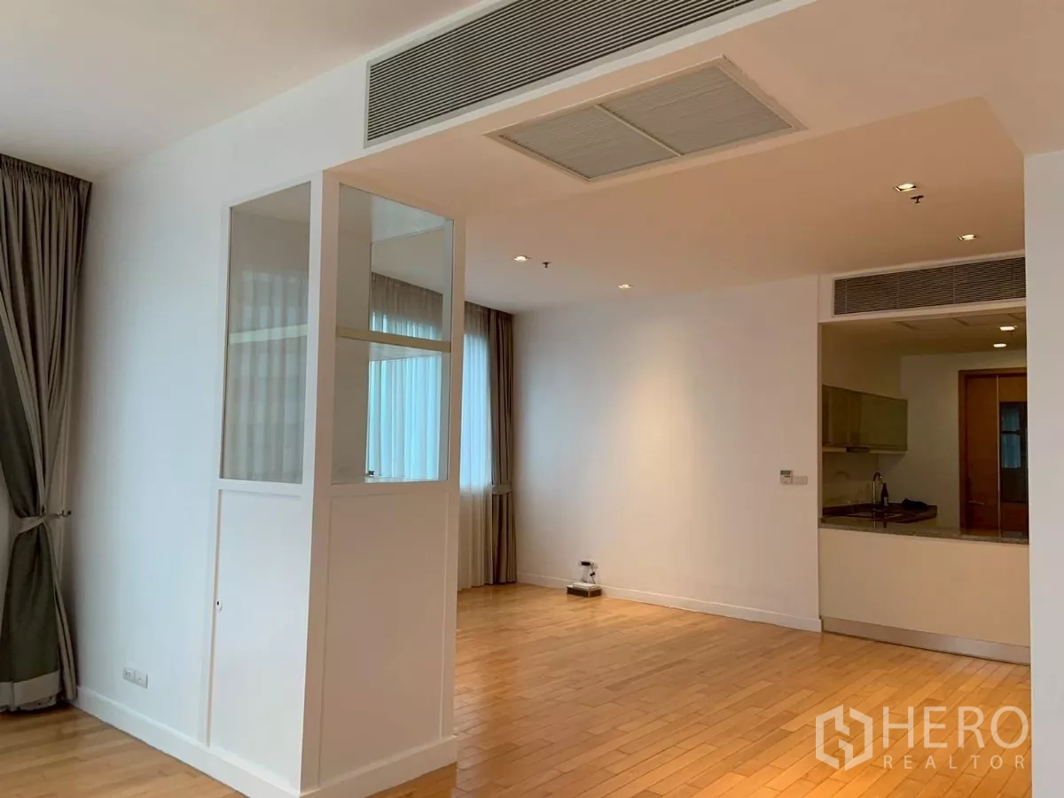 Condominium for rent in Khlong Toei, Bangkok - Partitioned area with built-in glass cabinet and view toward a semi-open kitchen.