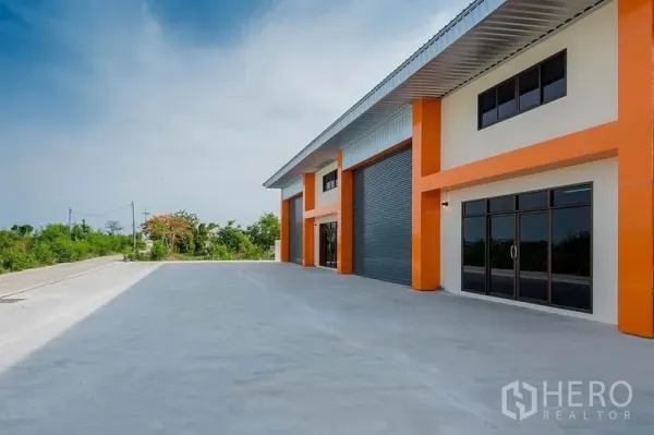 โรงงาน ขายในBang Sao Thong, Samut Prakan - มุมมองด้านข้างของโรงงาน มีประตูกระจกทางเข้าออฟฟิศและช่องโหลด ประกอบด้วยทางวิ่งรถกว้างติดพื้นที่สีเขียว