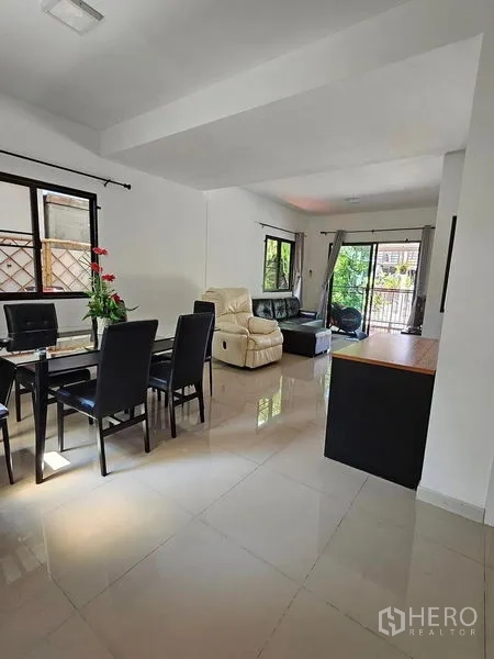 Townhouse for rent - Spacious ground floor layout showing dining zone, lounge and sliding doors to the front patio.