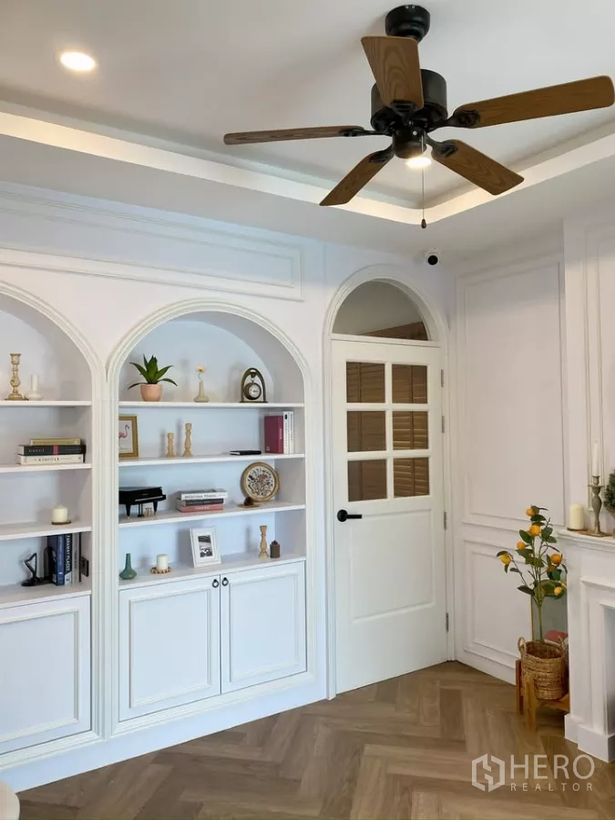 Detached House for sale in Sai Mai, Bangkok - Built-in arched shelves beside a glass-panel door in a study area.