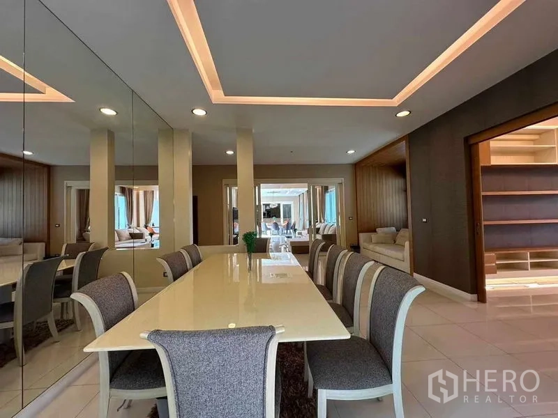 Detached House for rent or sale in Bang Phli, Samut Prakan - Formal dining room with long table, mirrored wall and recessed lighting