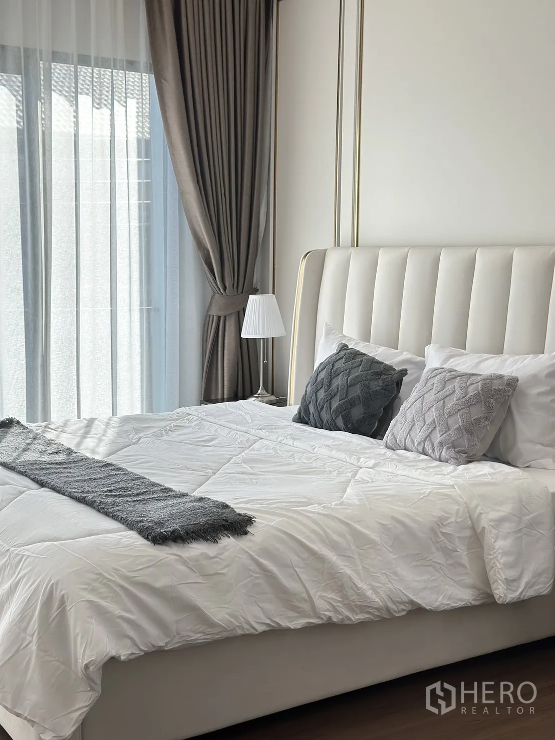 Detached House for rent or sale - Sunlit bedroom with tall upholstered headboard, layered curtains and neutral bedding.