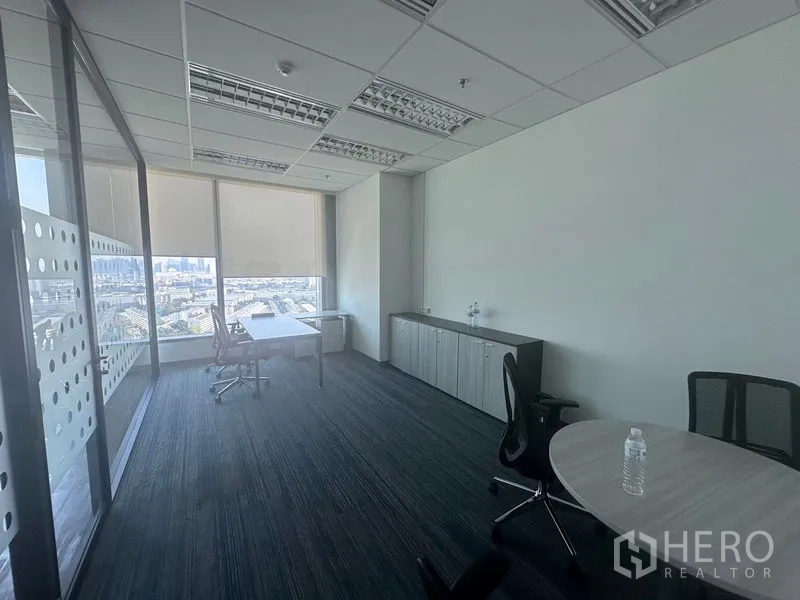 Office Space for rent in Ratchathewi, Bangkok - Private office with cabinets, desk and city view through blinds.