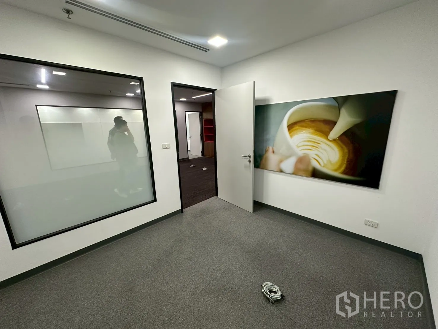 Office Space for rent - Small office with interior glazing, wall art and grey carpet.