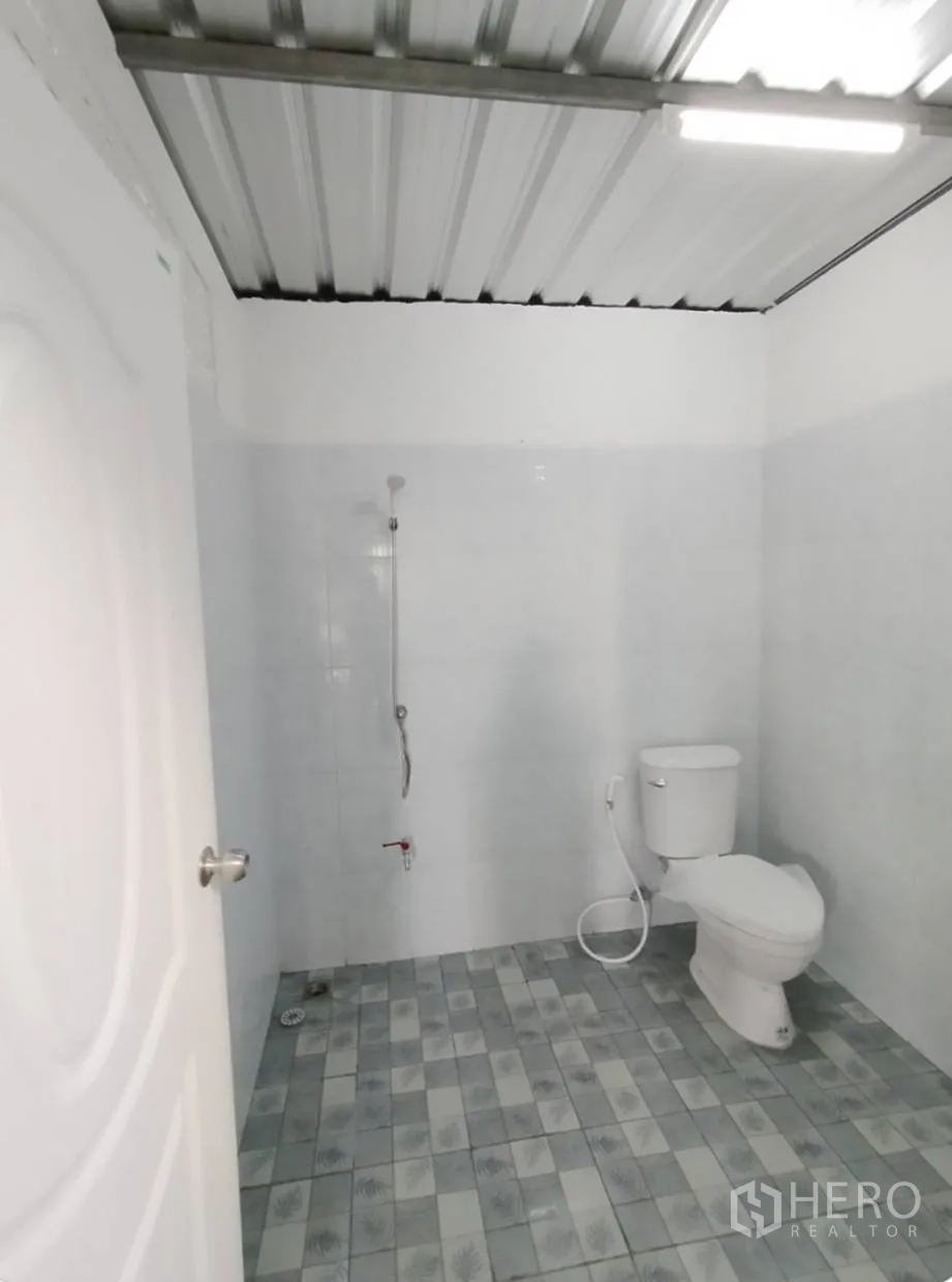 โกดัง for rent in Bang Khen, Bangkok - ห้องน้ำโกดังสะอาด ผนังกระเบื้องสีขาว พร้อมฝักบัวและโถสุขภัณฑ์ พื้นกระเบื้องลาย