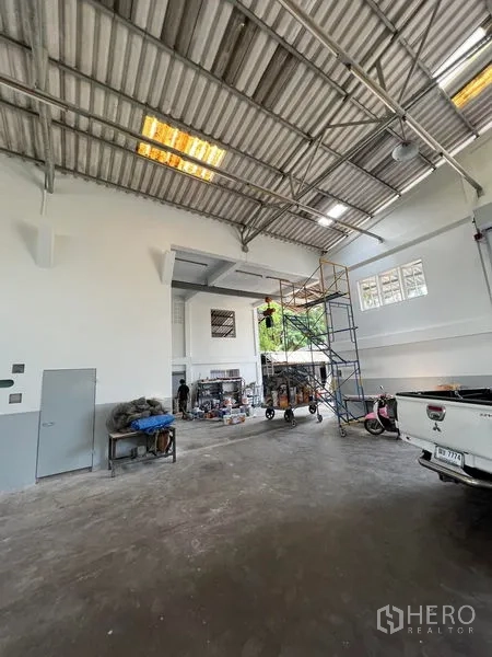 货栈 出租在Thung Khru, Bangkok - 仓库内景含脚手架、侧窗、服务门与开放式生产空间。