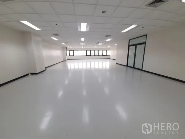 Office Space for rent in Bang Rak, Bangkok - Open workspace looking back toward the window wall and glazed entry door.