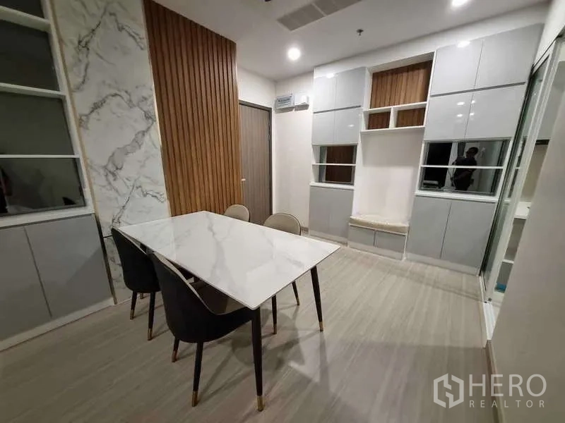Condominium for rent - Dining area with marble-top table and four upholstered chairs.