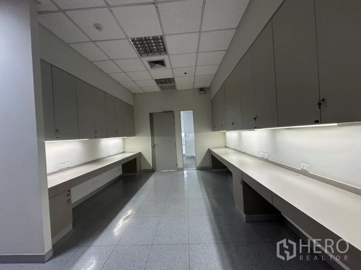 Office Space for rent in Watthana, Bangkok - Workroom with long built-in counters, under-cabinet lighting and ample storage.