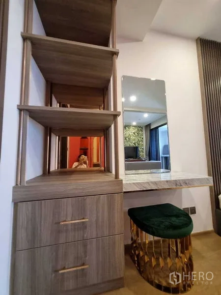 Condominium for rent in Bang Rak, Bangkok - Built-in shelving and dressing table with mirror and stool.