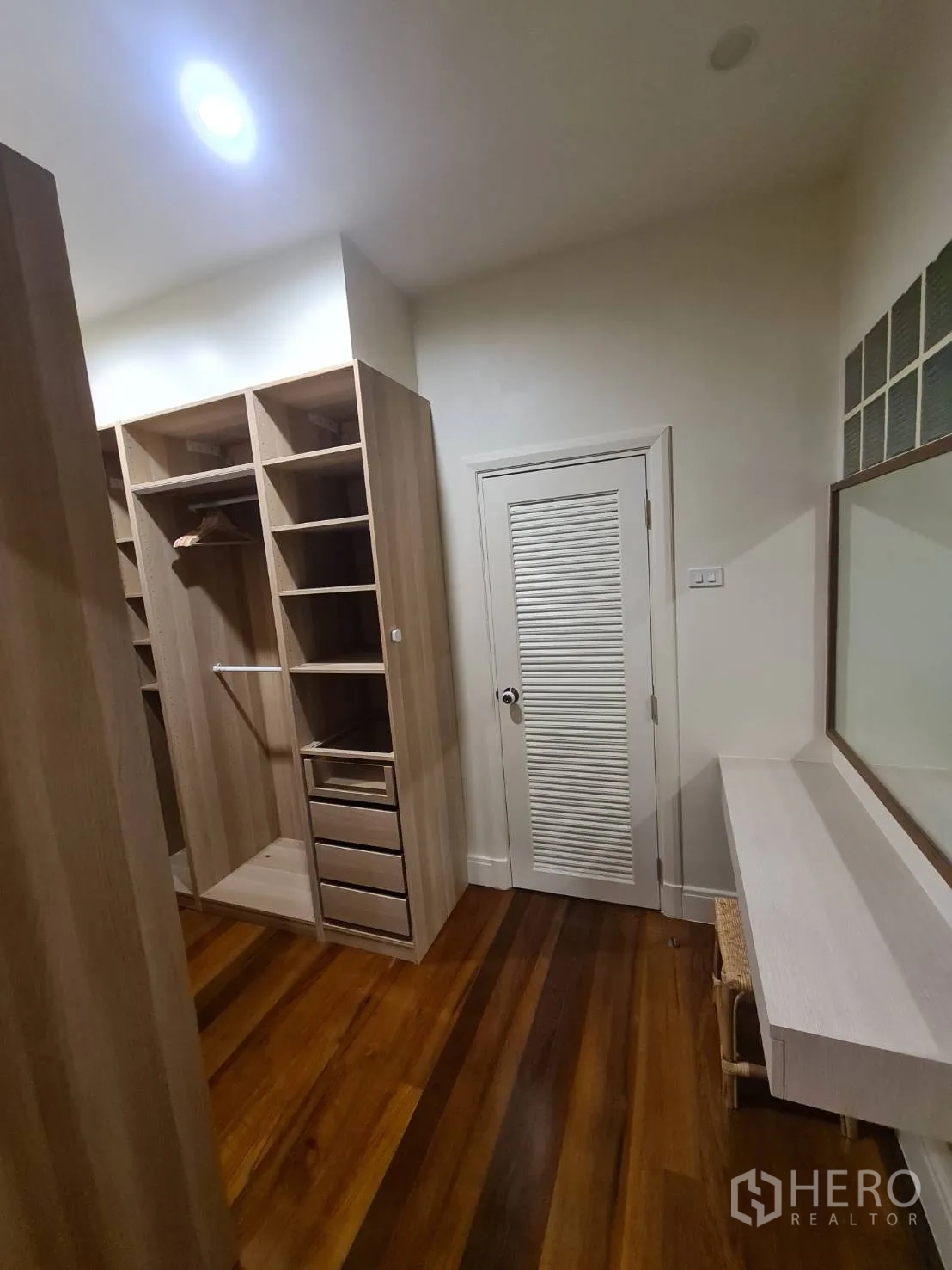 Detached House for rent in Khlong Toei, Bangkok - Walk-in closet with custom shelving, drawers and a dressing table.