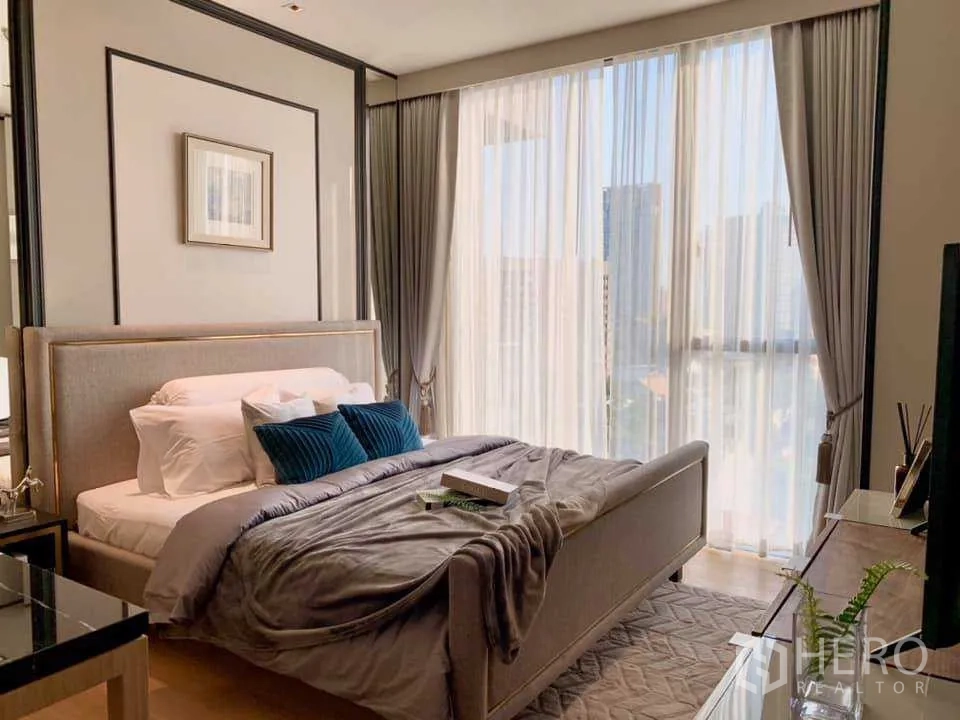 Condominium for rent in Khlong Toei, Bangkok - Bright bedroom with floor-to-ceiling windows, soft drapes and city view.