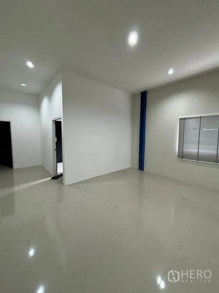 Warehouse for rent in Krathum Baen, Samut Sakhon - Clean ground-floor office space with white walls, tiled flooring and a side window.