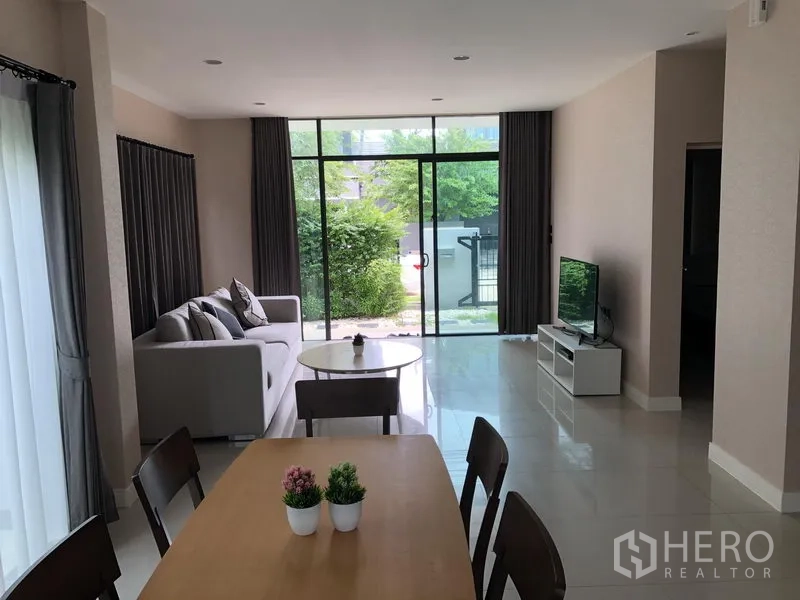 Detached House for rent or sale in Bang Kapi, Bangkok - Bright open-plan living and dining area with floor-to-ceiling sliding glass doors to a small garden in Hua Mak, Bang Kapi.