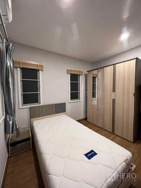 独立式住宅 出租或出售在Lat Krabang, Bangkok - 次卧配单人床、衣柜和双窗。