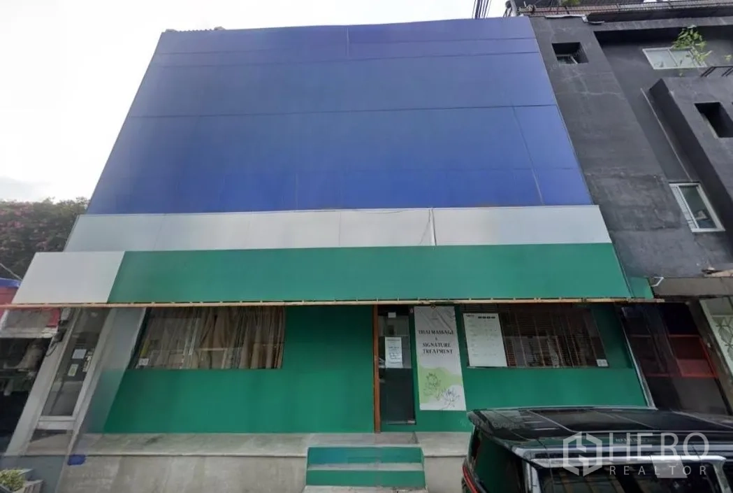 Retail Space for rent in Khlong Toei, Bangkok - Street‑facing retail frontage with wide blue facade, green awning and step entrance.