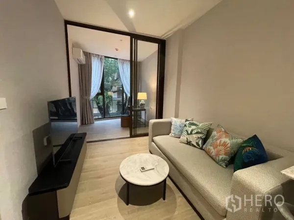 Condominium for rent in Khlong Toei, Bangkok - Cozy lounge opening via sliding glass to bedroom or study with large windows