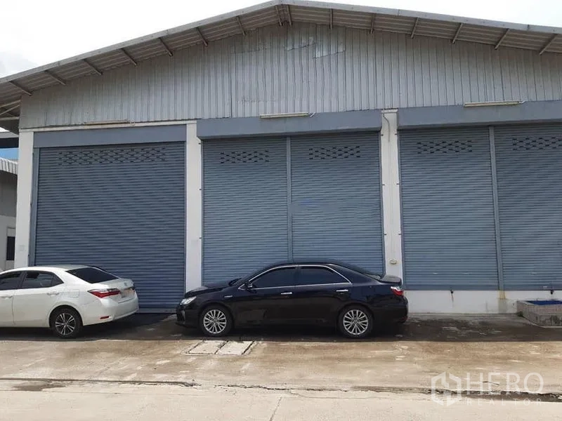 Warehouse for rent in Bang Phli, Samut Prakan - Metal-clad warehouse exterior with three large roller shutters and parking bay.
