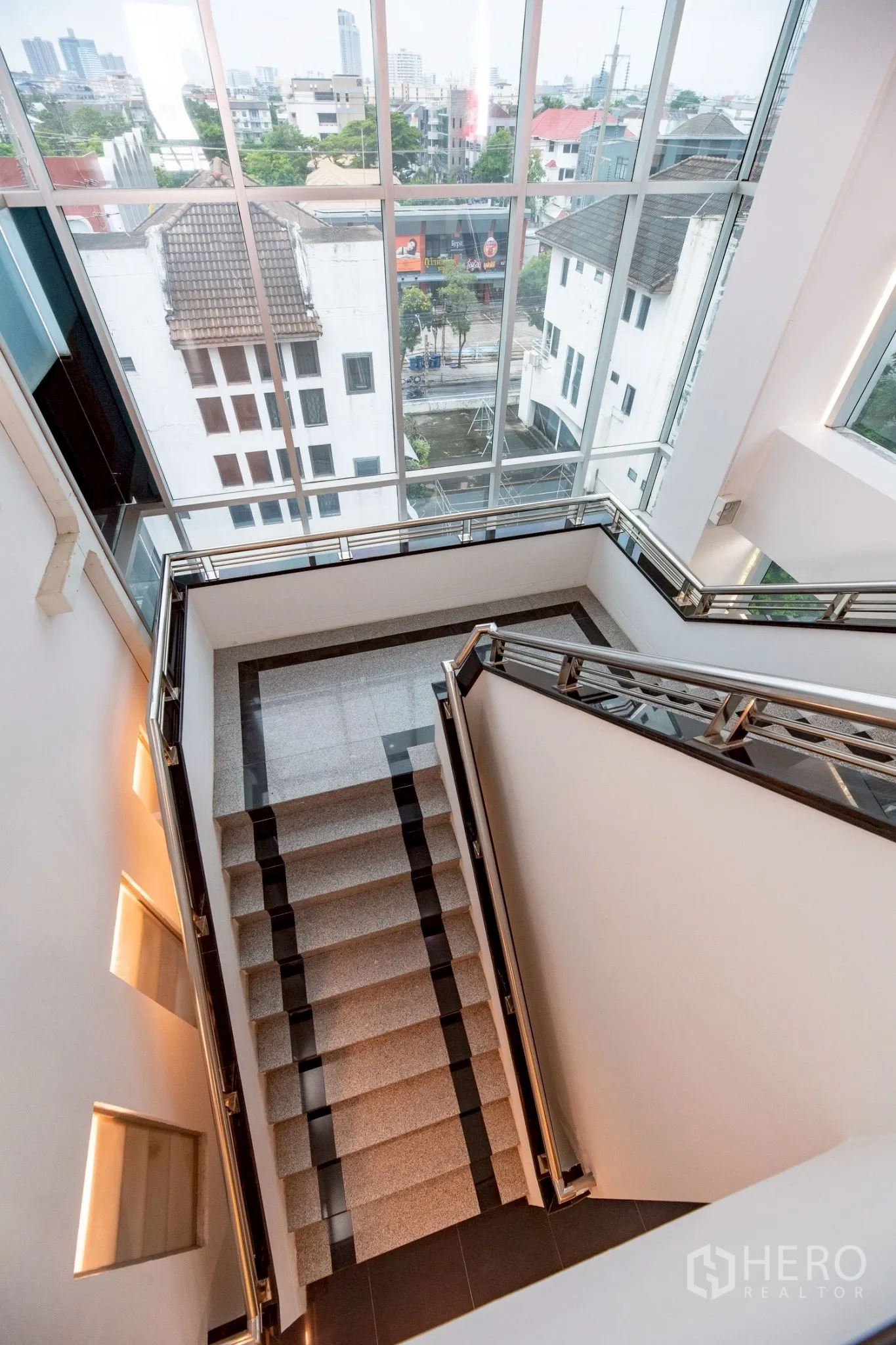 Office Space for rent in Wang Thonglang, Bangkok - Staircase with floor-to-ceiling windows offering city views.